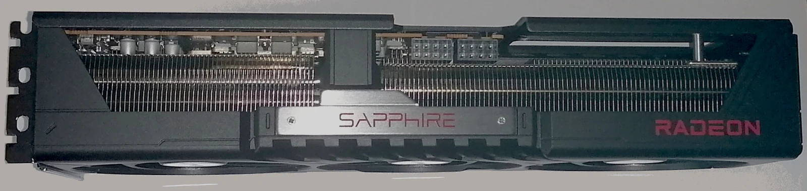 Real side-view photograph of a Sapphire Pulse Radeon RX 9070 XT graphics card.