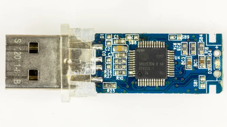 Real macro photograph of a USB flash drive with its internal circuit board visible.