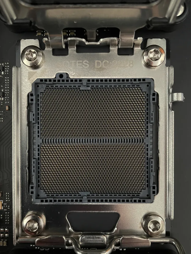 Real close-up of an open AM5 CPU socket and its retention frame.